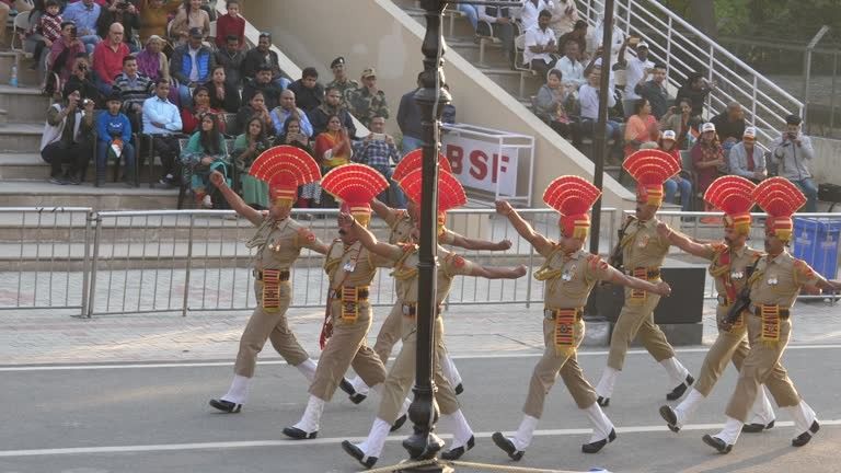 Border Security Force soldiers performing the ceremonial parade at the Attari-Wagah Border as spectators watch from the grandstands.