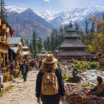 Foreign traveler exploring a charming Himalayan mountain town beside a riverside promenade, surrounded by traditional wooden architecture, local cafés, vibrant market stalls, and snow-capped peaks, capturing the scenic beauty and cultural atmosphere of northern India.