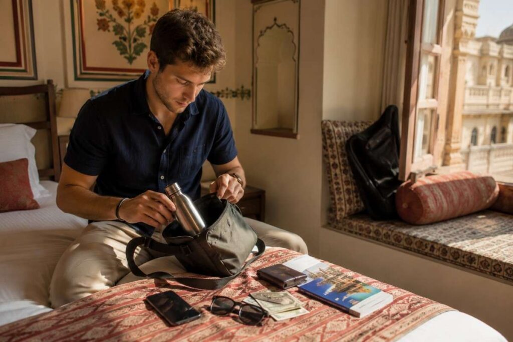 Foreign tourist organizing passport, cash, phone, and travel essentials in a hotel room before exploring India with a UPI payment wallet.